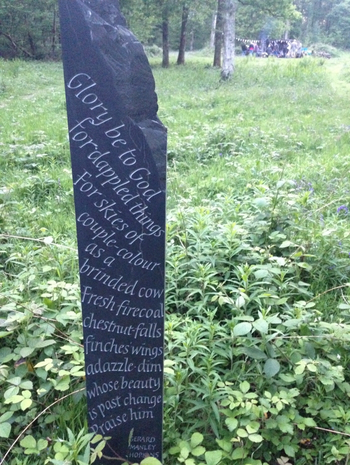 Text of a poem on a slate in a wood