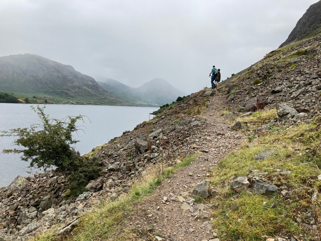Fell walkers on sloping scree path
